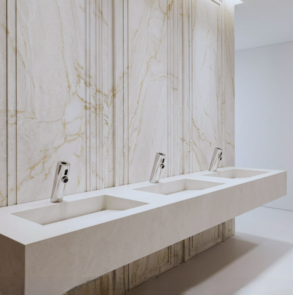 Large public restroom interior representing stadium-scale plumbing demand